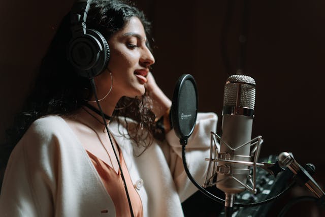 Young woman recording her vocals.
